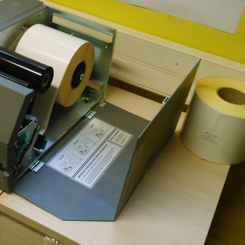Thermal label printer loaded with a roll of labels