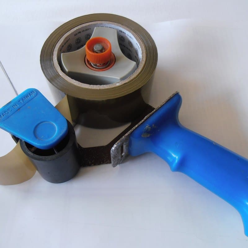 Hand dispenser with a roll of packing tape